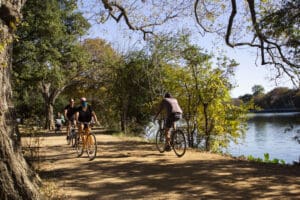 Cyclists ride along Lady Bird Lake on the Ann and Roy Butler Hike-and-Bike Trail